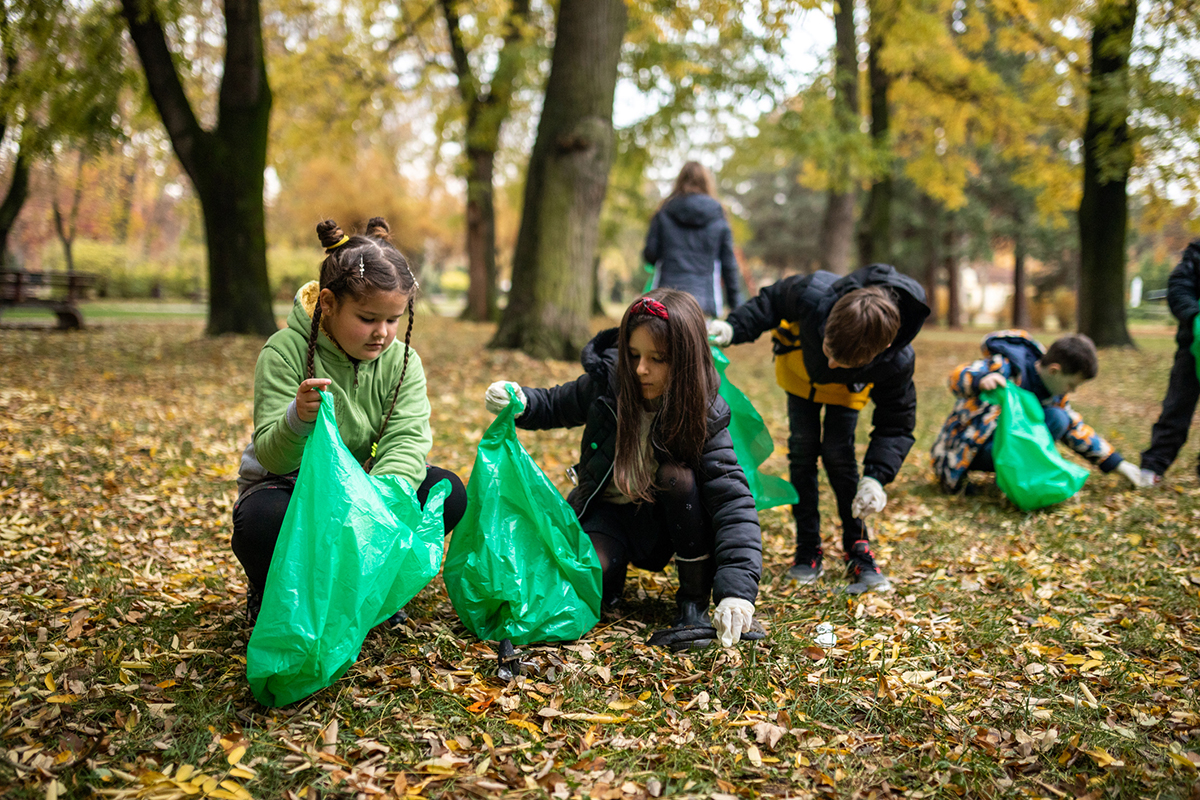 Group of children clean up the park on Earth Day.